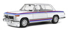 1:18 scale white diecast model car with blue and red racing stripes, classic design
