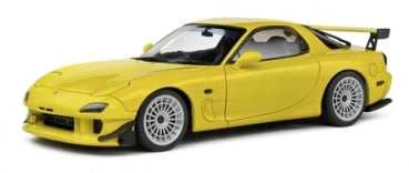 Yellow 1:18 scale diecast sports car model with detailed wheels and rear spoiler