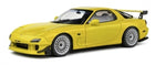 Yellow diecast model sports car with rear wing and silver rims, 1:18 scale