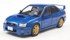 1:18 scale blue Subaru Impreza diecast model car with gold wheels and rear spoiler