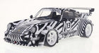 1:18 scale diecast Porsche model car with black and white racing livery and large rear wing
