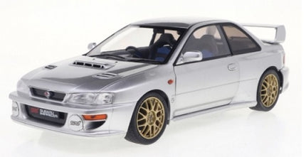 Silver diecast Subaru Impreza model car with gold wheels, 1:18 scale, sports styling