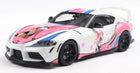 1:18 scale diecast Toyota Supra model car, white with pink anime-themed graphics and black wheels