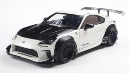 1:18 scale diecast model of white and black Toyota sports car with wide body kit and rear wing