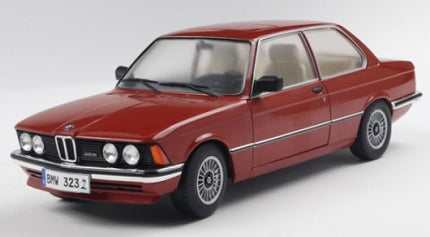 Red BMW 323 diecast model car in 1:18 scale, classic design, on white background.