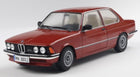 Red BMW 323 diecast model car in 1:18 scale, classic design, on white background.