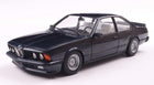 1:18 scale diecast model of a classic black BMW coupe on a white background
