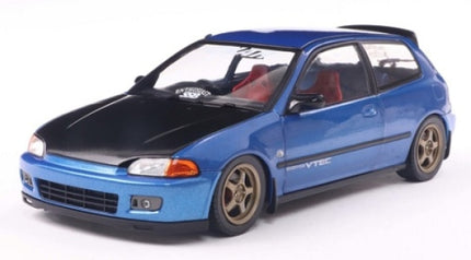 1:18 scale blue diecast model car with black hood, bronze wheels, red seats, hatchback style
