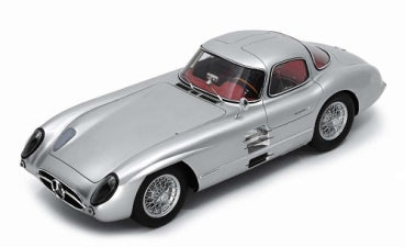 Silver 1:18 scale diecast model car with red interior and classic coupe design
