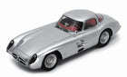 Silver diecast model car in 1:18 scale with red interior, classic coupe design
