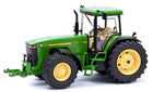 Green diecast model tractor with yellow wheels, detailed cab and realistic features