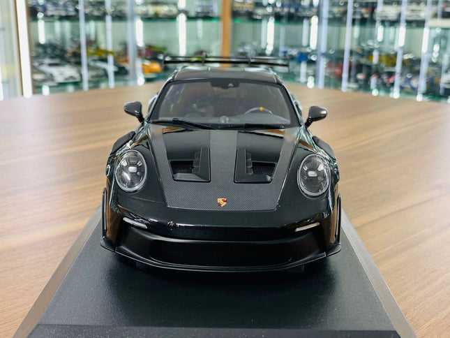 Minichamps Porsche 911 992 GT3 RS 2023 1:18 Diecast Model Black - studio product photo of the scale model