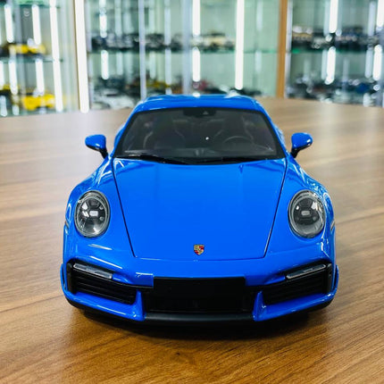 Minichamps Porsche 911 Turbo S Coupe Sport Design 2021 1/18 Diecast Model Car Blue - studio product photo of the scale model