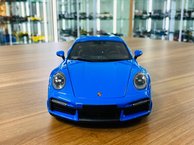 Minichamps Porsche 911 Turbo S Coupe Sport Design 2021 1/18 Diecast Model Car Blue - studio product photo of the scale model
