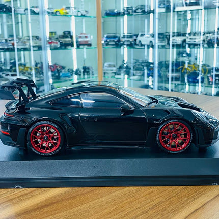 Minichamps Porsche 911 992 GT3 RS 2023 1:18 Black with Red Wheels Diecast Model - studio product photo of the scale model