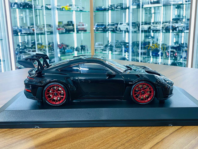 Minichamps Porsche 911 992 GT3 RS 2023 1:18 Black with Red Wheels Diecast Model - studio product photo of the scale model