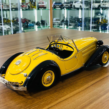 CMC 1/18 Audi Front 225 Roadster 1935 Yellow/Black Diecast Model Car - studio product photo of the scale model