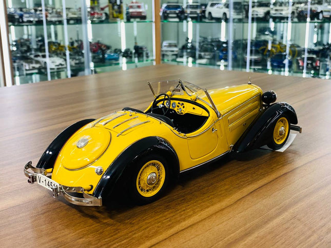 CMC 1/18 Audi Front 225 Roadster 1935 Yellow/Black Diecast Model Car - studio product photo of the scale model
