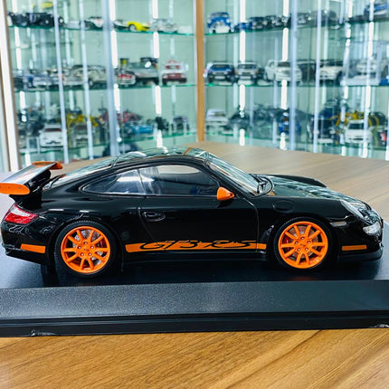 Minichamps Porsche 911 GT3 RS 2007 1:18 Diecast Model Black Orange - studio product photo of the scale model