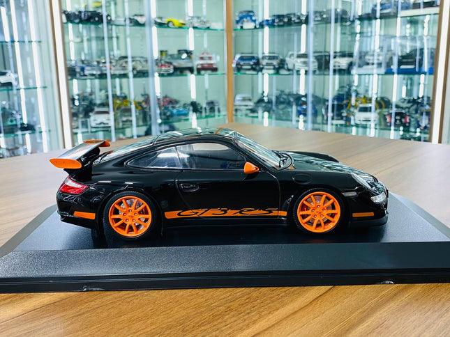 Minichamps Porsche 911 GT3 RS 2007 1:18 Diecast Model Black Orange - studio product photo of the scale model