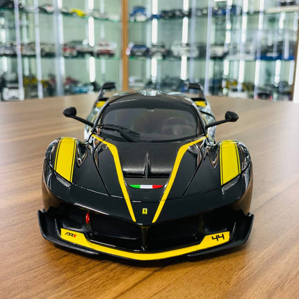 Bburago Signature Series Ferrari FXX K #44 1/18 Diecast Model Car Black/Yellow - studio product photo of the scale model
