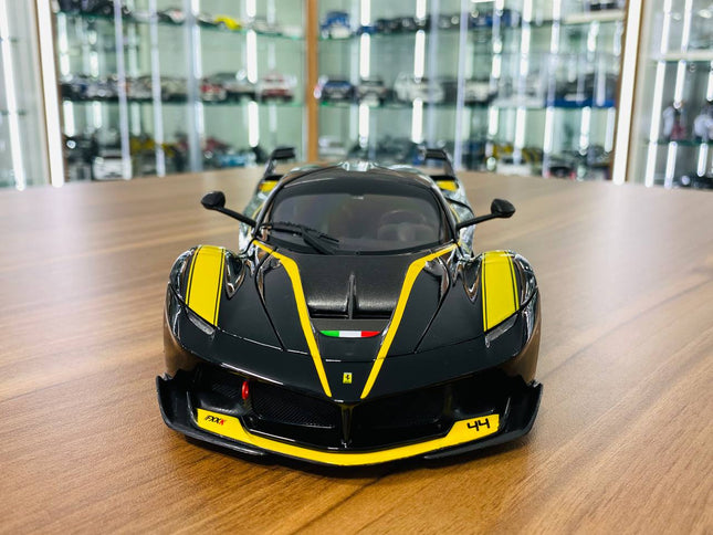 Bburago Signature Series Ferrari FXX K #44 1/18 Diecast Model Car Black/Yellow - studio product photo of the scale model