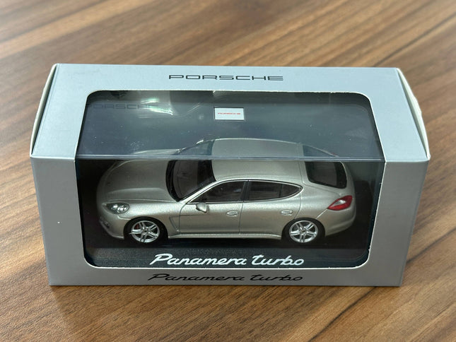Minichamps Porsche Panamera Turbo – Gold – 1:43 Diecast Model - studio product photo of the scale model
