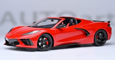 Red 1:18 scale diecast model sports car with black wheels and detailed exterior