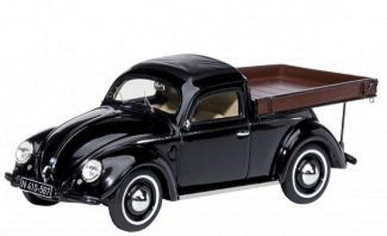 Black vintage diecast pickup truck model car with whitewall tires on white background
