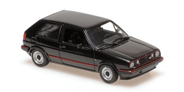 Black 1:18 scale diecast model hatchback car with red stripe, detailed exterior, on white background.