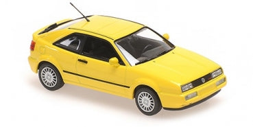 Yellow 1:18 scale diecast model car, coupe design, black trim, detailed wheels