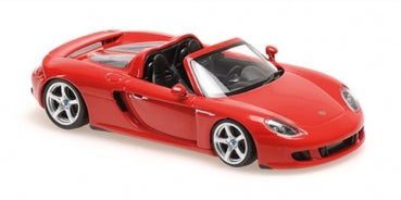 Red diecast Porsche convertible model car with black interior, 1:18 scale, on white background.