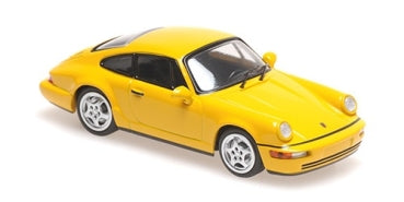 Yellow diecast model Porsche car in 1:18 scale with detailed exterior features.