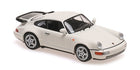 White Porsche diecast model car 1:18 scale, classic sports car collectible on white background
