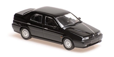 Black diecast model sedan car, 1:18 or 1:24 scale, isolated on white background.