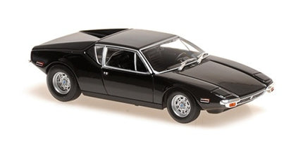 Black diecast model car in 1:18 scale, vintage sports coupe, detailed silver wheels.