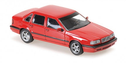 Red diecast model car, 1:18 scale, four-door sedan with detailed wheels and black trim