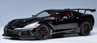 1:18 scale black diecast Corvette model car with rear spoiler and red interior