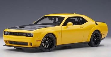 Yellow 1:18 scale diecast model car with black hood and sporty details on display