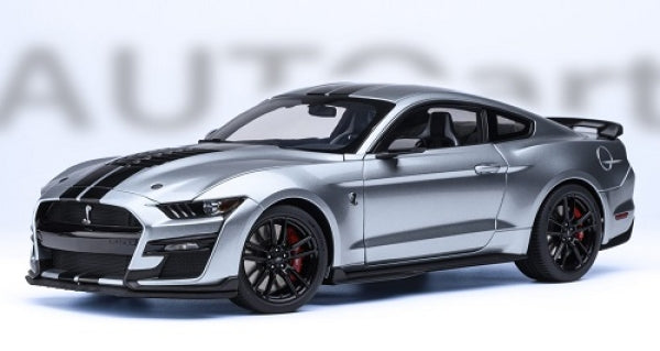 Silver diecast model car in 1:18 scale, Shelby GT500, black racing stripes, sporty design
