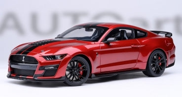 Red diecast model car in 1:18 scale with black racing stripes and detailed rims