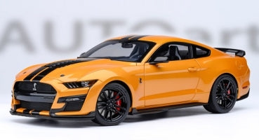1:18 scale orange diecast model sports car with black racing stripes and black wheels