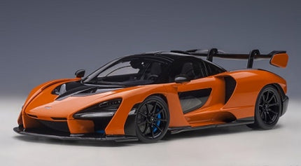 Orange diecast model car with black accents and rear wing, 1:18 scale sports car replica