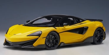 Yellow 1:18 scale diecast model sports car with black roof and detailing, angled side view