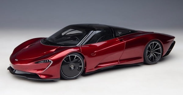 Red diecast model supercar with black roof and detailed rims, 1:18 scale on plain background