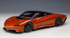 Orange 1:18 scale diecast model sports car with black roof and sleek aerodynamic design