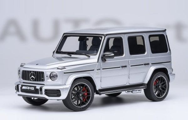 Silver 1:18 scale diecast model Mercedes G-Class SUV with detailed black accents and red brake calipers