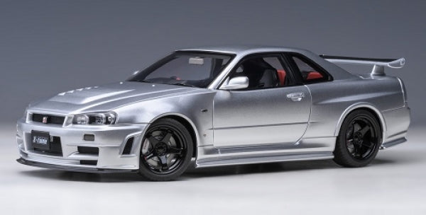 Silver diecast model car, 1:18 scale Nissan Skyline GT-R R34 with black wheels and rear spoiler