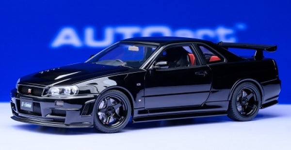 1:18 scale black diecast Nissan Skyline GT-R model car with sporty details on blue background