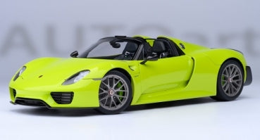 Lime green 1:18 scale Porsche 918 Spyder diecast model car with detailed wheels and interior.